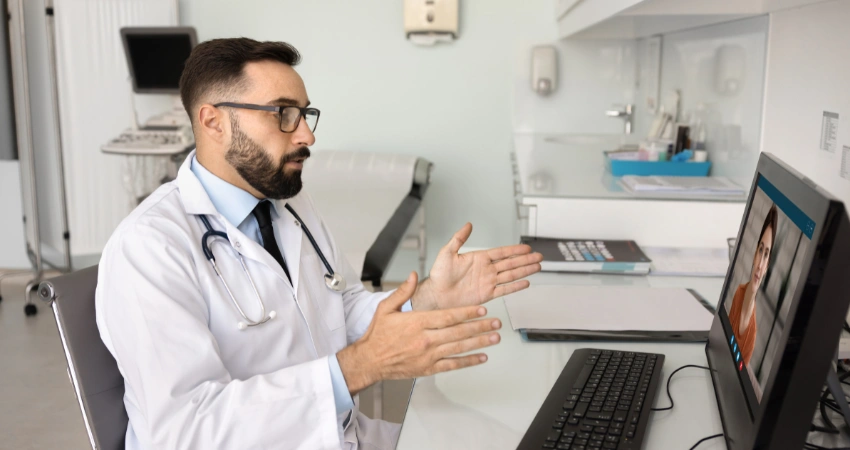 Image of a doctor providing medication-assisted treatment through a virtual telehealth consultation