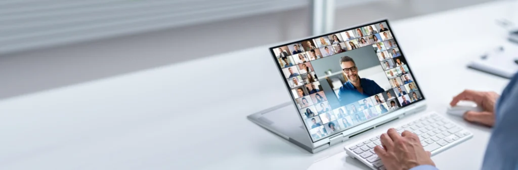 Image of a man sitting at his laptop, and attending an online recovery support meeting - How to Find the Right Online Recovery Support Groups - Shanti Recovery and Wellness