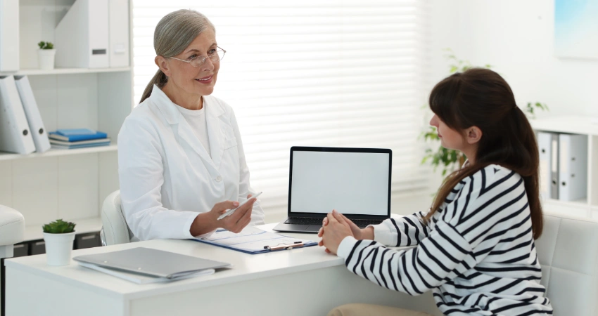 Image of a clinician assessing a patient to determine if a higher level of care is clinically indicated