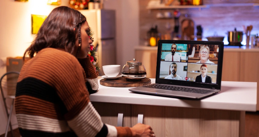 Image of a person attending an online addiction recovery support group meeting late at nigh