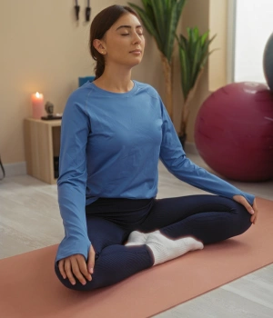 Image of woman practicing deep breathing meditation coping skills stress relief recovery home