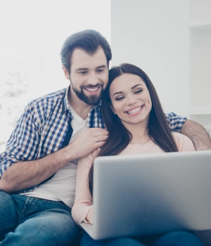 Image of a couple engaged in a telehealth therapy session together at home