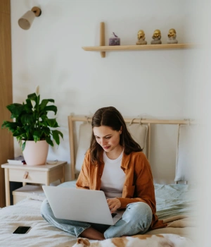 Image of a woman in a calm home setting participating in a virtual addiction treatment session for ongoing recovery support