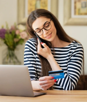 Image of a woman on the phone verifying her insurance coverage and enrollment for a women's virtual IOP program