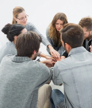 Image of people talking and connecting at an AA support group meeting for community recovery support