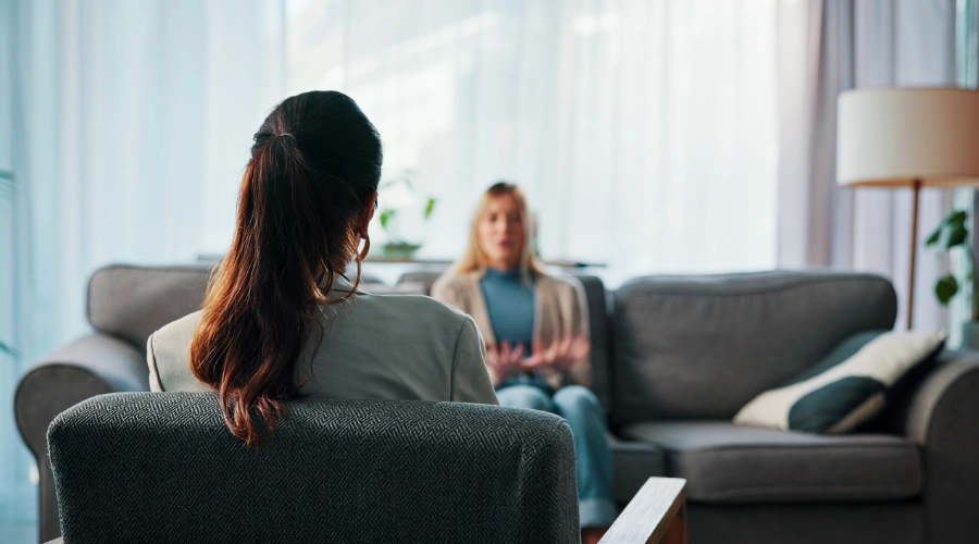 Image of a woman in a therapy session with her therapist discussing the difference between a slip and a relapse in recovery