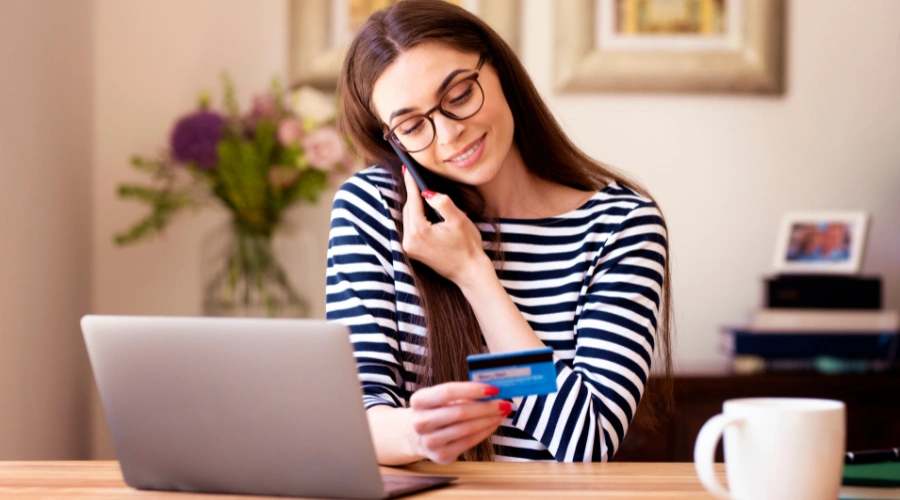 Image of a woman on the phone verifying her insurance coverage and discussing relapse-related treatment costs and benefits