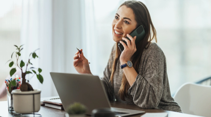 Image of a woman on the phone with an admissions counselor making her first contact to start an IOP program