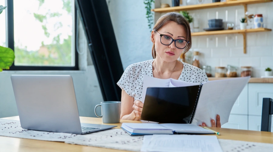 Image of a woman organizing her insurance card and documents as part of the IOP admissions process