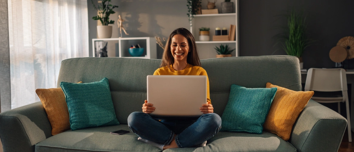 Image of a woman smiling at her laptop ready to begin her PHP recovery journey at Shanti Recovery & Wellness