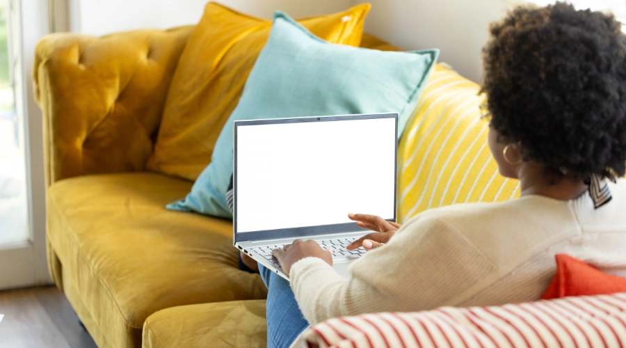 Image of a woman at her laptop in a quiet private space prepared for a secure virtual IOP therapy session