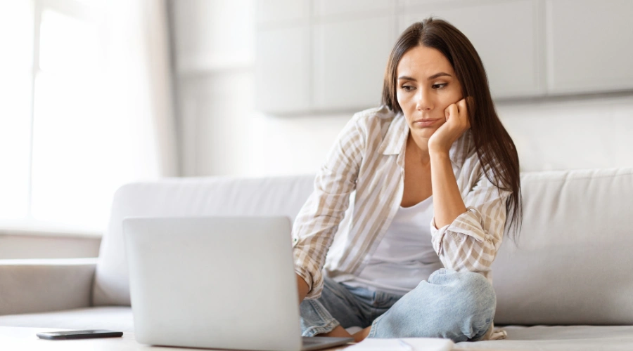 Image of a woman in a home on a video call with her therapist receiving virtual addiction treatment