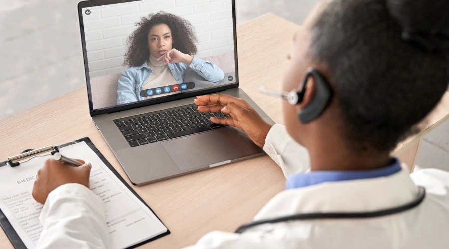 Image of a woman on a telehealth video call receiving online psychiatric medication management and mental health treatment