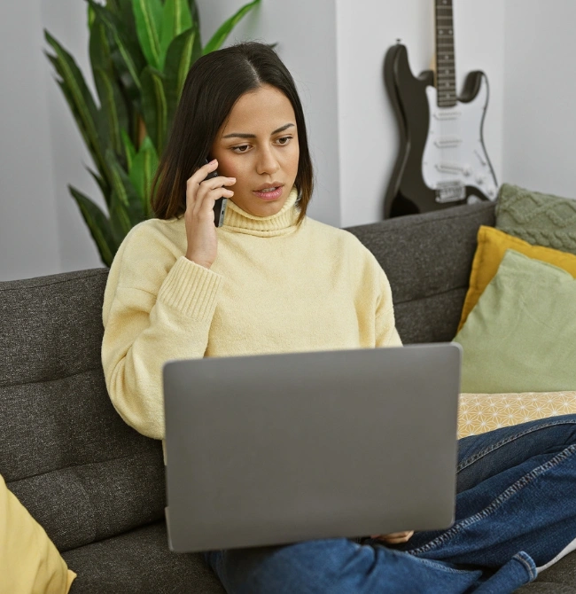 Image of a woman on the phone verifying insurance information and discussing payment arrangements for virtual addiction treatment