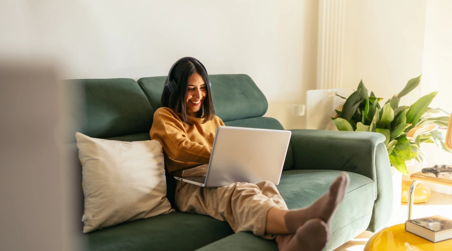 Image of a woman smiling at her laptop ready to begin her personalized virtual IOP plan with Shanti Recovery & Wellness