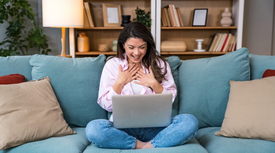 Image of a woman smiling at her laptop ready to continue her recovery with a clear next step at Shanti Recovery & Wellness